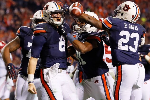 AUBURN, AL - NOVEMBER 25:  Jarrett Stidham #8 of the Auburn Tigers celebrates with teammates after rushing for a touchdown against the Alabama Crimson Tide at Jordan Hare Stadium on November 25, 2017 in Auburn, Alabama.  (Photo by Kevin C. Cox/Getty Images)