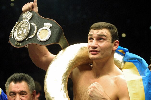 FILE - In this Jan. 28, 2001, file photo, Vitali Klitschko, of Ukraine, shows the world championship belt. after he knocked out Orlin Norris, of the United States, in the first round of a WBO heavyweight title fight in Munich, Germany. Former heavyweight champion Vitali Klitschko, four-division world champion Erik Morales, and light middleweight champion Ronald Wright have been elected to the International Boxing Hall of Fame on Tuesday, Dec. 5, 2017. The Induction ceremony is June 10, 2018, in Canastota, N.Y.  (AP Photo/Camay Sungu, File)
