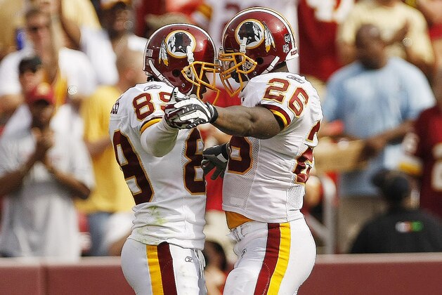 Washington Redskins Santana Moss (89) and Clinton Portis (26) celebrate after Moss converted a 4th down reception for 8 yards and a first down to clinch their win late in the 4th quarter during their NFL game against the New Orleans Saints at Fedex Field in Landover, Sunday, Sept. 14, 2008. The Redskins won 29-24. (AP Photo/Gerald Herbert)