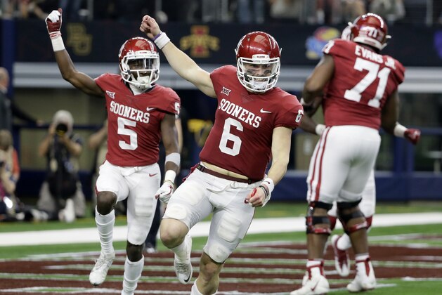 Oklahoma quarterback Baker Mayfield (6) and wide receiver Marquise Brown (5) celebrate hooking up for a long pass and touchdown score in the second half of the Big 12 Conference championship NCAA college football game against TCU on Saturday, Dec. 2, 2017, in Arlington, Texas. (AP Photo/Tony Gutierrez)