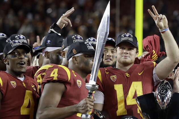 Southern California quarterback Sam Darnold (14) and teammates celebrate after defeating Stanford 31-28 in the Pac-12 Conference championship NCAA college football game in Santa Clara, Calif., Friday, Dec. 1, 2017. (AP Photo/Marcio Jose Sanchez)