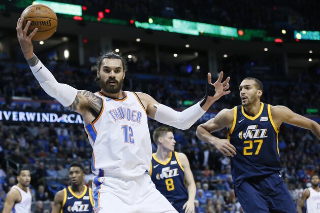 Oklahoma City Thunder center Steven Adams (12) grabs a rebound in front of Utah Jazz center Rudy Gobert (27) in the first quarter of an NBA basketball game in Oklahoma City, Tuesday, Dec. 5, 2017. Oklahoma City won 100-94. (AP Photo/Sue Ogrocki)
