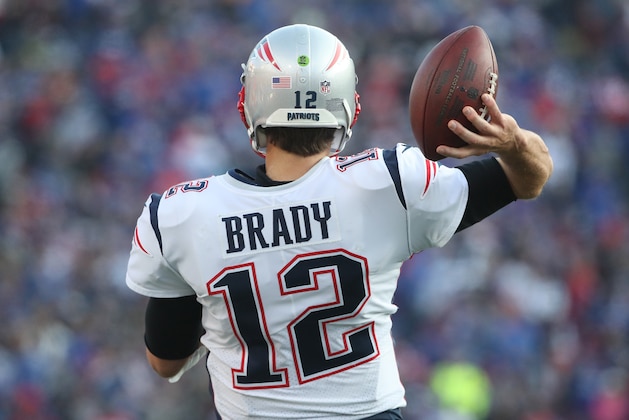 BUFFALO, NY - DECEMBER 3: Tom Brady #12 of the New England Patriots throws the football on the sideline as he stays loose during NFL game action against the Buffalo Bills at New Era Field on December 3, 2017 in Buffalo, New York. (Photo by Tom Szczerbowski/Getty Images)