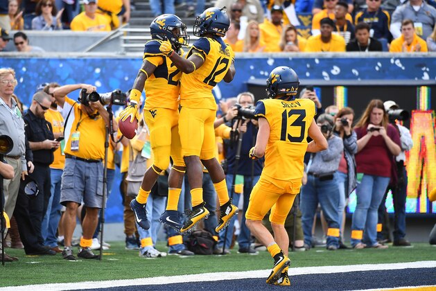 MORGANTOWN, WV - SEPTEMBER 09:  Justin Crawford #25 of the West Virginia Mountaineers celebrates his second quarter touchdown with Gary Jennings #12 against the East Carolina Pirates at Mountaineer Field on September 9, 2017 in Morgantown, West Virginia. (Photo by Joe Sargent/Getty Images)