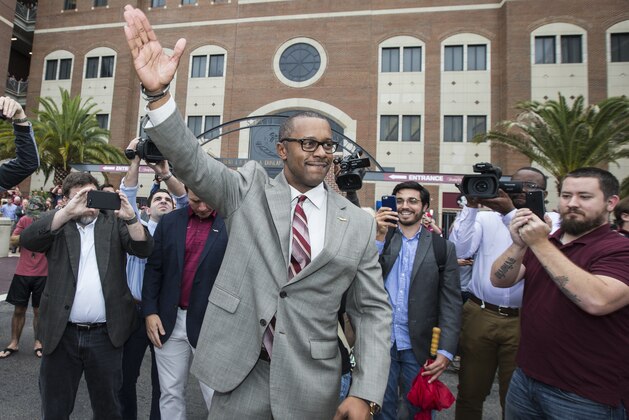 Willie Taggart does the Seminole chop in front of Doak Campbell Stadium before being introduced as Florida State University's new NCAA college football coach in Tallahassee, Fla., Wednesday, Dec. 6, 2017. (AP Photo/Mark Wallheiser)