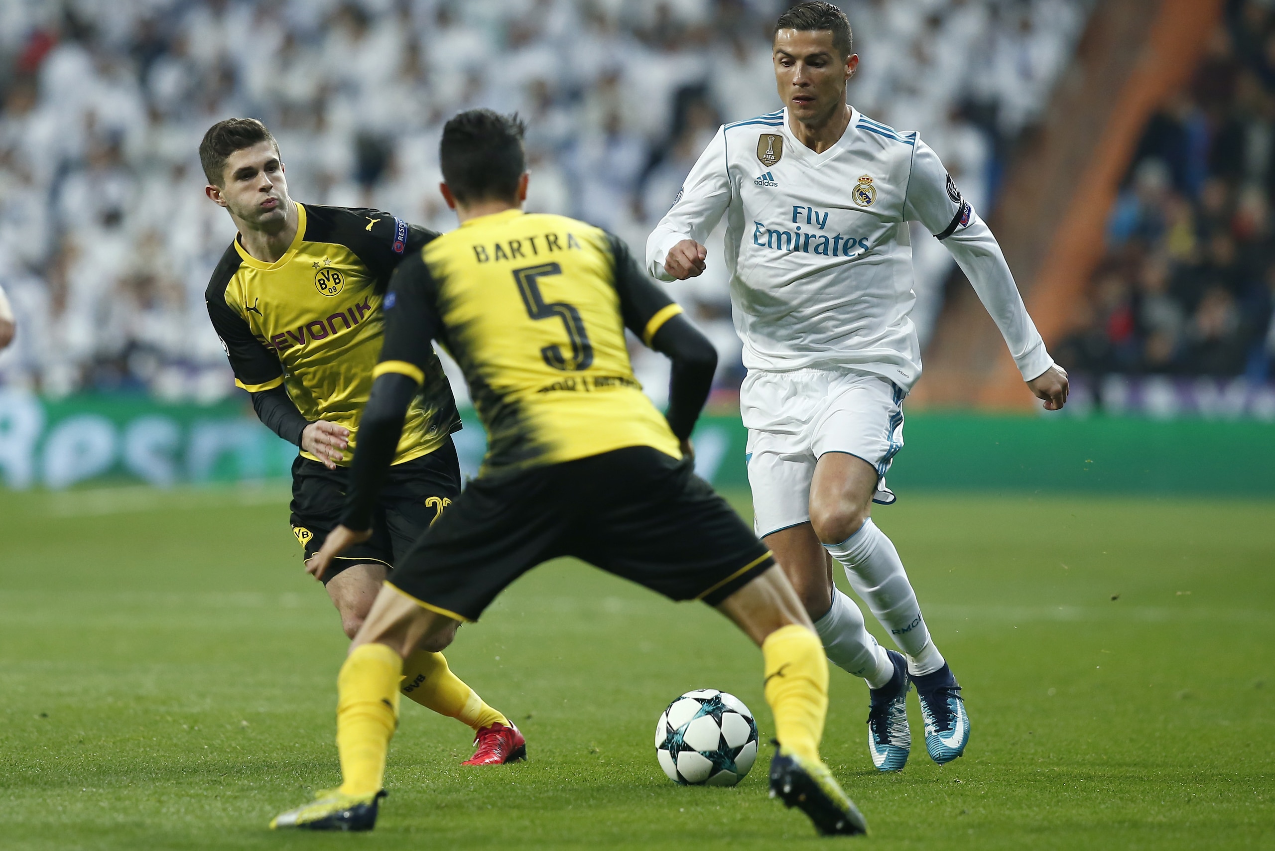 MADRID, SPAIN - DECEMBER 06: Cristiano Ronaldo of Real Madrid attempts to get past Marc Bartra of Borussia Dortmund during the UEFA Champions League group H match between Real Madrid and Borussia Dortmund at Estadio Santiago Bernabeu on December 6, 2017 in Madrid, Spain.  (Photo by Gonzalo Arroyo Moreno/Getty Images)
