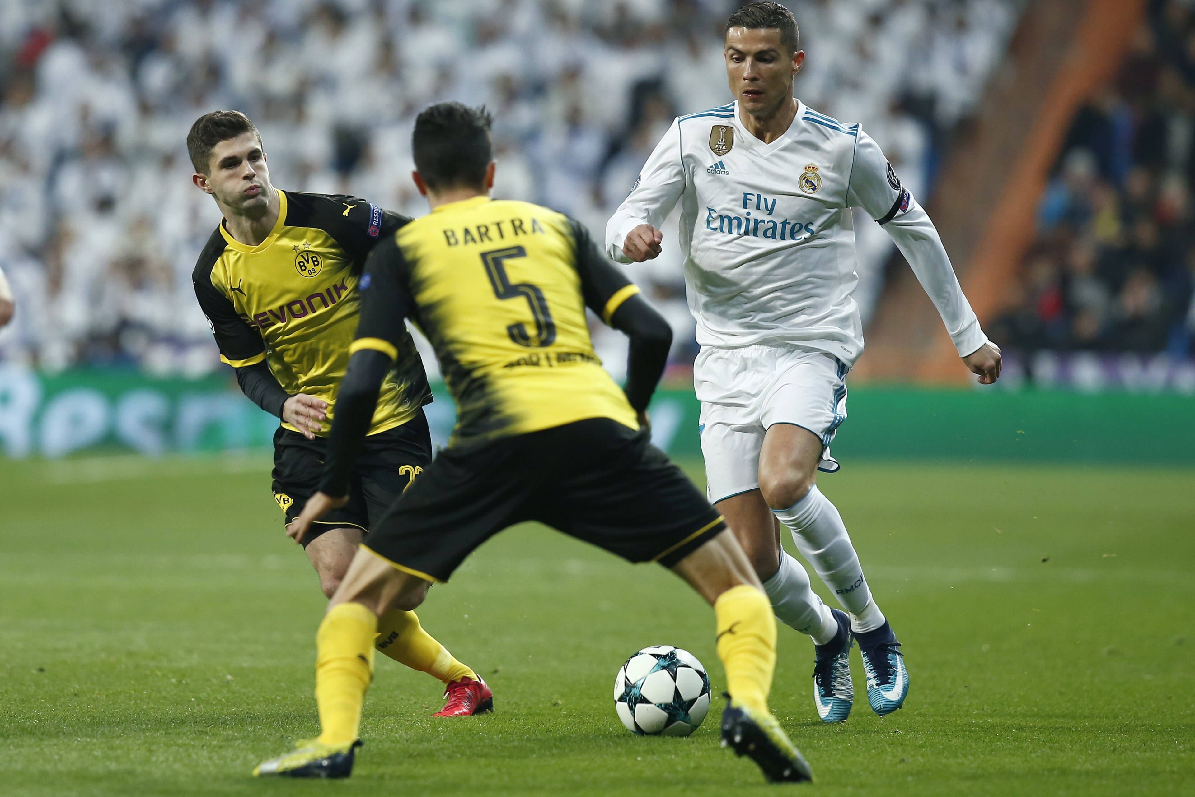 MADRID, SPAIN - DECEMBER 06: Cristiano Ronaldo of Real Madrid attempts to get past Marc Bartra of Borussia Dortmund during the UEFA Champions League group H match between Real Madrid and Borussia Dortmund at Estadio Santiago Bernabeu on December 6, 2017 in Madrid, Spain.  (Photo by Gonzalo Arroyo Moreno/Getty Images)