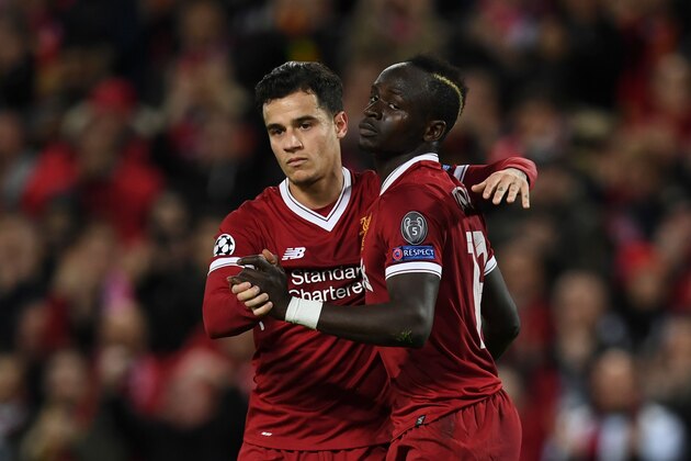 Liverpool's Senegalese midfielder Sadio Mane (R) celebrates scoring their sixth goal with Liverpool's Brazilian midfielder Philippe Coutinho (L) during the UEFA Champions League Group E football match between Liverpool and Spartak Moscow at Anfield in Liverpool, north-west England on December 6, 2017. / AFP PHOTO / Paul ELLIS        (Photo credit should read PAUL ELLIS/AFP/Getty Images)