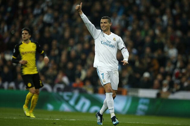 Real Madrid's Cristiano Ronaldo celebrates after he scored his side's second goal during the Champions League Group H soccer match between Real Madrid and Borussia Dortmund at the Santiago Bernabeu stadium in Madrid, Spain, Wednesday, Dec. 6, 2017. (AP Photo/Paul White)