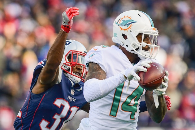 FOXBORO, MA - NOVEMBER 26: Jarvis Landry #14 of the Miami Dolphins carries the ball as he is tackled by Jonathan Jones #31 of the New England Patriots during the second quarter of a game at Gillette Stadium on November 26, 2017 in Foxboro, Massachusetts. (Photo by Adam Glanzman/Getty Images) FOXBORO, MA - NOVEMBER 26: Jarvis Landry #14 of the Miami Dolphins carries the ball as he is tackled by Jonathan Jones #31 of the New England Patriots during the second quarter of a game at Gillette Stadium on November 26, 2017 in Foxboro, Massachusetts. (Photo by Adam Glanzman/Getty Images)