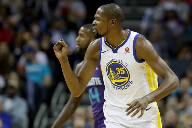 CHARLOTTE, NC - DECEMBER 06:  Kevin Durant #35 of the Golden State Warriors reacts after a play against the Charlotte Hornets during their game at Spectrum Center on December 6, 2017 in Charlotte, North Carolina.  NOTE TO USER: User expressly acknowledges and agrees that, by downloading and or using this photograph, User is consenting to the terms and conditions of the Getty Images License Agreement.  (Photo by Streeter Lecka/Getty Images)