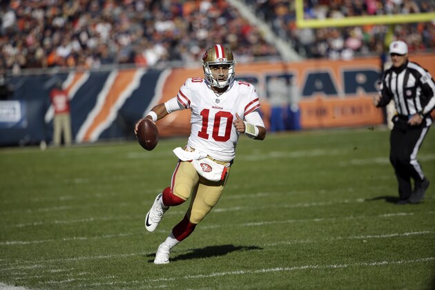 San Francisco 49ers quarterback Jimmy Garoppolo (10) scrambles during the first half of an NFL football game against the Chicago Bears, Sunday, Dec. 3, 2017, in Chicago. (AP Photo/Nam Y. Huh)