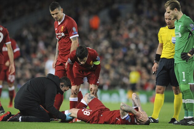 Liverpool's Alberto Moreno, center, receives a medical help during the Champions League Group E soccer match between Liverpool and Spartak Moscow at Anfield, Liverpool, England, Wednesday, Dec. 6, 2017. (AP Photo/Rui Vieira)