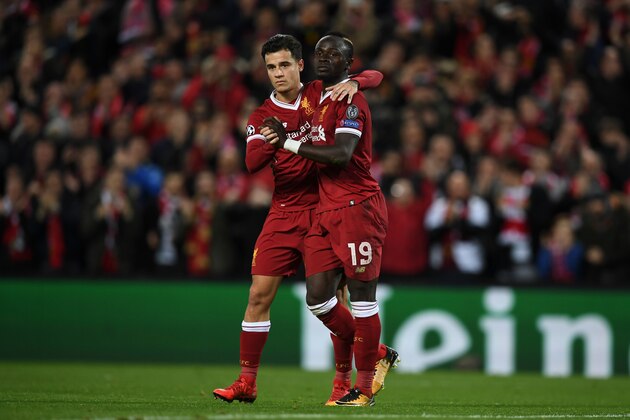 Liverpool's Senegalese midfielder Sadio Mane (R) celebrates scoring their sixth goal with Liverpool's Brazilian midfielder Philippe Coutinho (L) during the UEFA Champions League Group E football match between Liverpool and Spartak Moscow at Anfield in Liverpool, north-west England on December 6, 2017. / AFP PHOTO / Paul ELLIS        (Photo credit should read PAUL ELLIS/AFP/Getty Images)