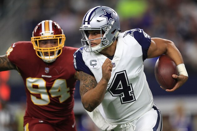 ARLINGTON, TX - NOVEMBER 30:  Preston Smith #94 of the Washington Redskins pursues Dak Prescott #4 of the Dallas Cowboys in the first half of a football game at AT&T Stadium on November 30, 2017 in Arlington, Texas.  (Photo by Ronald Martinez/Getty Images)