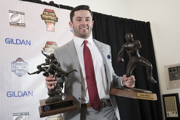 Oklahoma's Baker Mayfield holds the Davey O'Brien National Quarterback Award, right, and Walter Camp Player of the Year trophy during the College Football Awards show at the College Football Hall of Fame, Thursday, Dec. 7, 2017, in Atlanta. (AP Photo/John Amis)