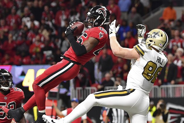 Atlanta Falcons middle linebacker Deion Jones (45) intercepts a ball in the end zone ahead of New Orleans Saints tight end Josh Hill (89) during the second half of an NFL football game, Thursday, Dec. 7, 2017, in Atlanta. The Falcons won 20-17. (AP Photo/Danny Karnik)