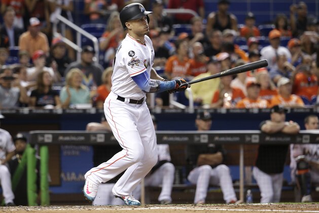 Miami Marlins' Giancarlo Stanton hits a single during the third inning of a baseball game against the Atlanta Braves, Sunday, Oct. 1, 2017, in Miami. (AP Photo/Lynne Sladky)