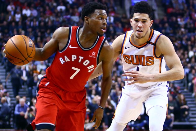 TORONTO, ON - December 05:  Kyle Lowry #7 of the Toronto Raptors dribbles the ball as Devin Booker #1 of the Phoenix Suns defends during the first half of an NBA game at Air Canada Centre on December 5, 2017 in Toronto, Canada.  NOTE TO USER: User expressly acknowledges and agrees that, by downloading and or using this photograph, User is consenting to the terms and conditions of the Getty Images License Agreement.  (Photo by Vaughn Ridley/Getty Images)