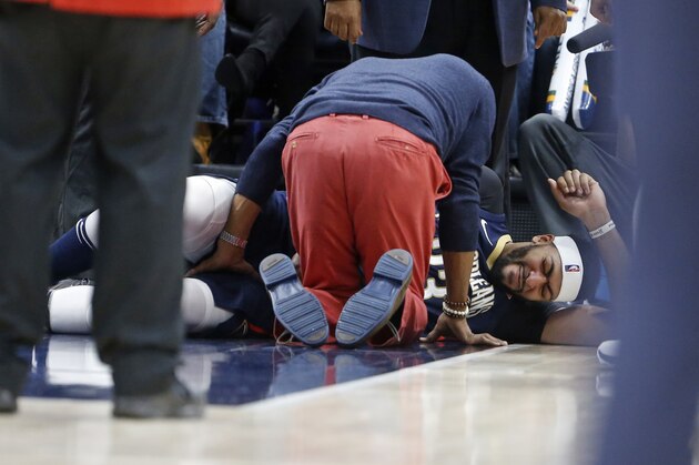 New Orleans Pelicans forward Anthony Davis lies on the court after being injured in the second half during an NBA basketball game against the Utah Jazz, Friday, Dec. 1, 2017, in Salt Lake City. (AP Photo/Rick Bowmer)