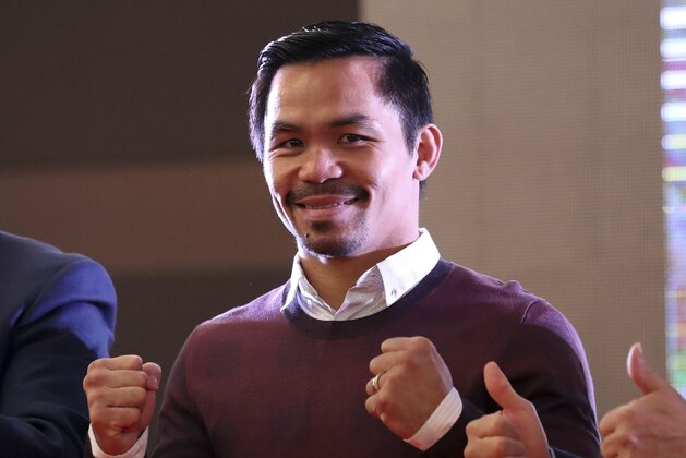Filipino boxer Manny Pacquiao poses for fans during a meeting with fans in Seoul, South Korea, Saturday, Dec. 24, 2016. Pacquiao arrived with his family on Friday to meet with fans and attend a charity bazaar during a Christmas. (AP Photo/Lee Jin-man)