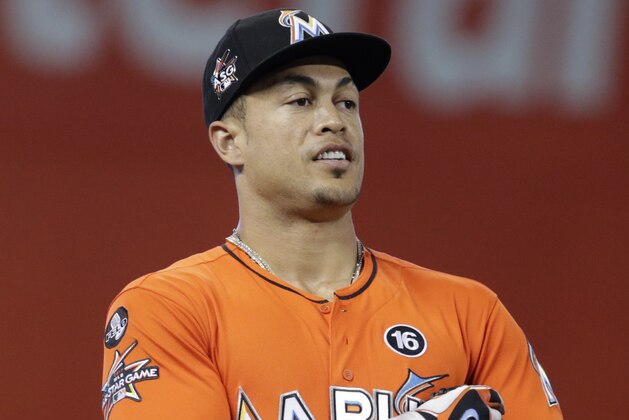 Miami Marlins right fielder Giancarlo Stanton stands on the field before a baseball game against the Philadelphia Phillies, Sunday, Sept. 3, 2017, in Miami. (AP Photo/Lynne Sladky)