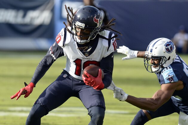 Tennessee Titans defensive back Logan Ryan, right, hangs on to the jersey of Houston Texans wide receiver DeAndre Hopkins (10) in the second half of an NFL football game Sunday, Dec. 3, 2017, in Nashville, Tenn. (AP Photo/Mark Zaleski)
