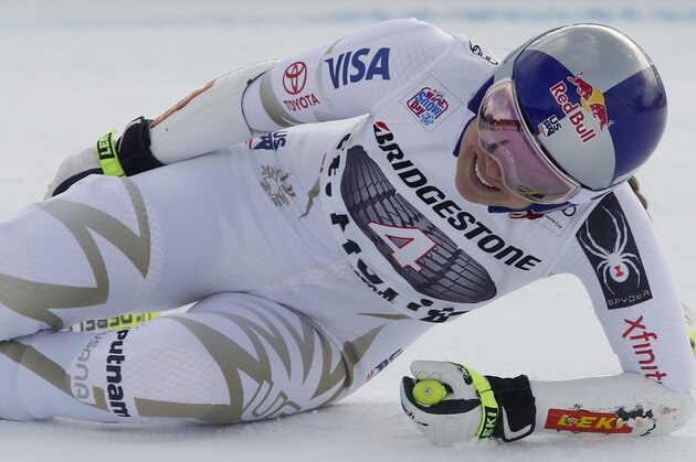 United States' Lindsey Vonn grimaces in pain after getting to the finish area of an alpine ski, women's World Cup super-G, in St. Moritz, Switzerland, Saturday, Dec. 9, 2017. (AP Photo/Giovanni Auletta)