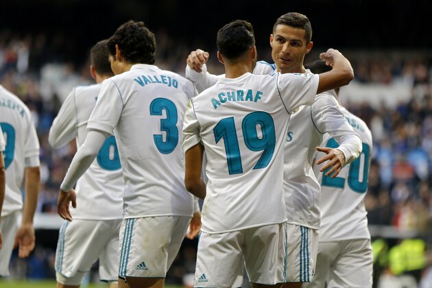 Real Madrid's Achraf, second right, celebrates with his teammate Cristiano Ronaldo after scoring his side's fifth goal against Sevilla during the Spanish La Liga soccer match between Real Madrid and Sevilla at the Santiago Bernabeu stadium in Madrid, Saturday, Dec. 9, 2017. (AP Photo/Francisco Seco)