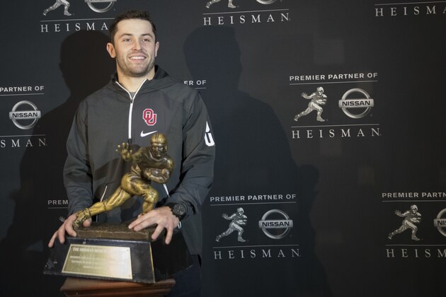 Heisman Trophy finalist, Oklahoma quarterback Baker Mayfield, poses with the award during a media event Friday, Dec. 8, 2017, in New York. (AP Photo/Mary Altaffer)