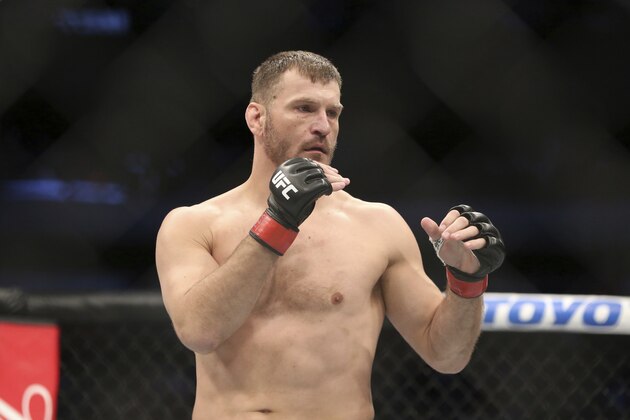 Stipe Miocic fights Junior Dos Santos in a mixed martial arts bout at UFC 211 for the UFC heavyweight championship, Saturday, May 13, 2017, in Dallas. Miocic retained his heavyweight title via 1st round TKO. (AP Photo/Gregory Payan)