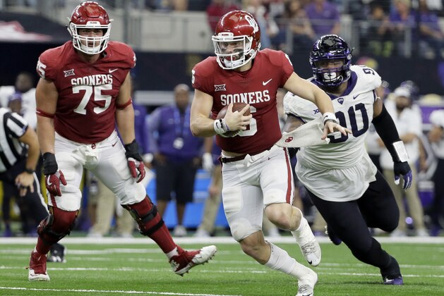 Oklahoma offensive lineman Dru Samia (75) watches as quarterback Baker Mayfield, front, is chased out of the pocket by TCU defensive tackle Ross Blacklock, right, in the second half of the Big 12 Conference championship NCAA college football game, Saturday, Dec. 2, 2017, in Arlington, Texas. (AP Photo/Tony Gutierrez)