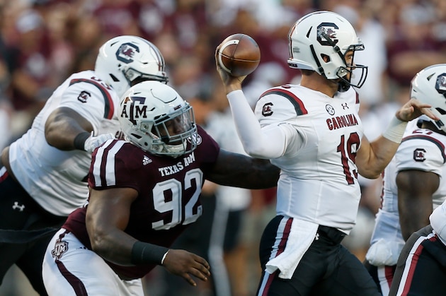 COLLEGE STATION, TX - SEPTEMBER 30:  Jake Bentley #19 of the South Carolina Gamecocks throws a pass as he receives pressure from Zaycoven Henderson #92 of the Texas A&M Aggies at Kyle Field on September 30, 2017 in College Station, Texas.  (Photo by Bob Levey/Getty Images)