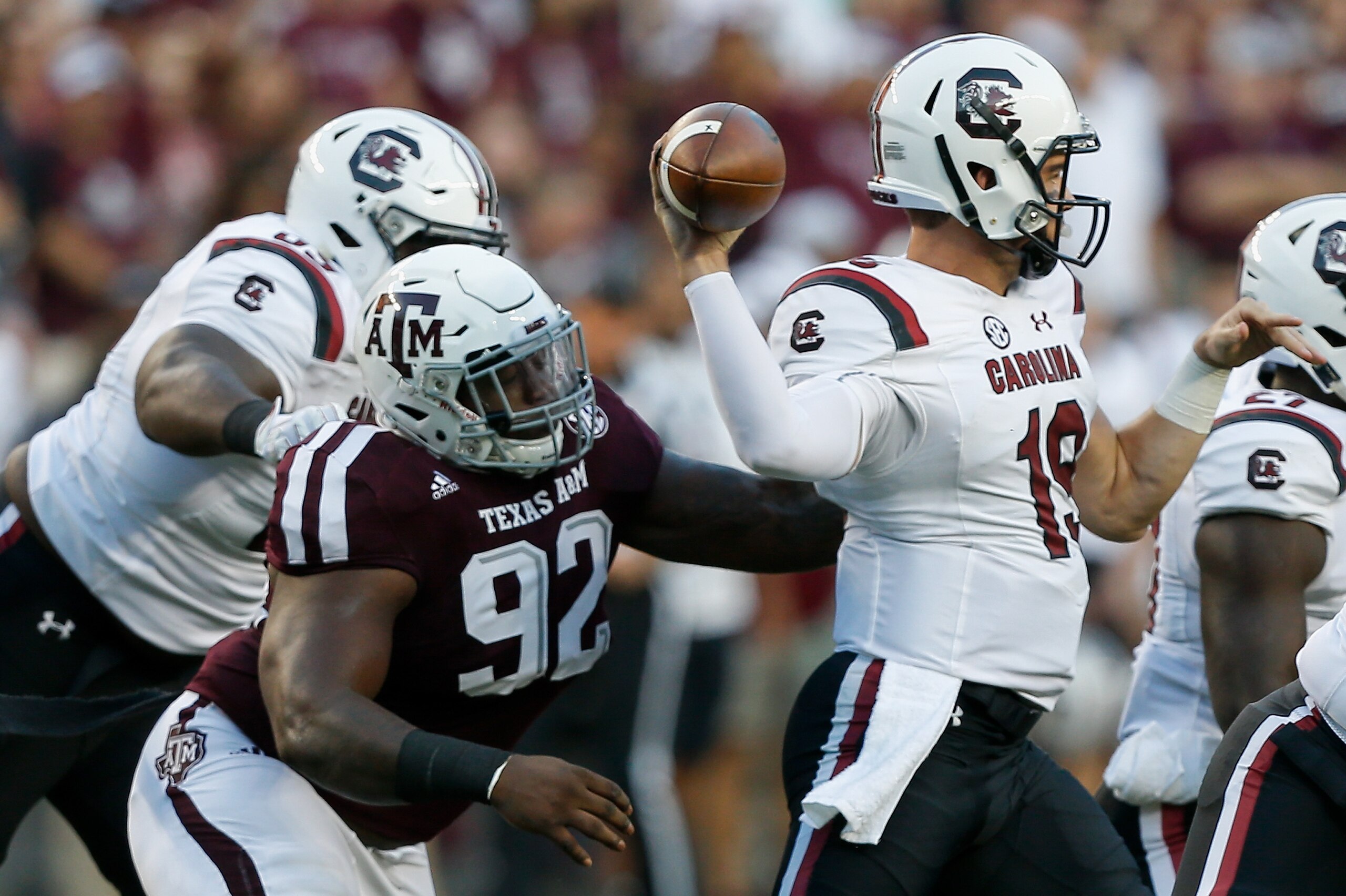 COLLEGE STATION, TX - SEPTEMBER 30:  Jake Bentley #19 of the South Carolina Gamecocks throws a pass as he receives pressure from Zaycoven Henderson #92 of the Texas A&M Aggies at Kyle Field on September 30, 2017 in College Station, Texas.  (Photo by Bob Levey/Getty Images)