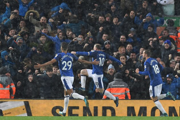 Everton's English striker Wayne Rooney (C) celebrates scoring an equalising goal from the penalty spot to make the score 1-1 during the English Premier League football match between Liverpool and Everton at Anfield in Liverpool, north west England on December 10, 2017.  / AFP PHOTO / Paul ELLIS / RESTRICTED TO EDITORIAL USE. No use with unauthorized audio, video, data, fixture lists, club/league logos or 'live' services. Online in-match use limited to 75 images, no video emulation. No use in betting, games or single club/league/player publications.  /         (Photo credit should read PAUL ELLIS/AFP/Getty Images)
