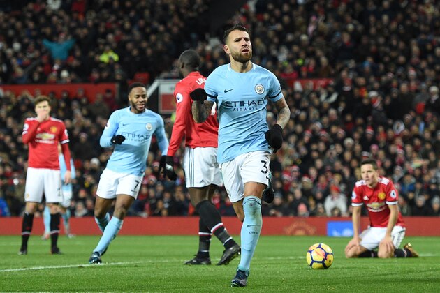 Manchester City's Argentinian defender Nicolas Otamendi (C) celebrates scoring their second goal during the English Premier League football match between Manchester United and Manchester City at Old Trafford in Manchester, north west England, on December 10, 2017. / AFP PHOTO / Oli SCARFF / RESTRICTED TO EDITORIAL USE. No use with unauthorized audio, video, data, fixture lists, club/league logos or 'live' services. Online in-match use limited to 75 images, no video emulation. No use in betting, games or single club/league/player publications.  /         (Photo credit should read OLI SCARFF/AFP/Getty Images)