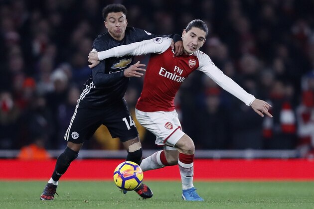 Manchester United's Jesse Lingard, left, fights for the ball with Arsenal's Hector Bellerin during the English Premier League soccer match between Arsenal and Manchester United at the Emirates stadium in London, Saturday, Dec. 2, 2017. (AP Photo/Kirsty Wigglesworth)