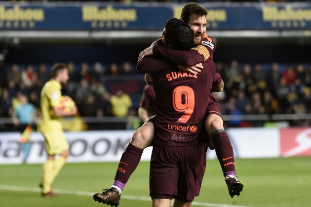 Barcelona's Argentinian forward Lionel Messi (L) celebrates  with Barcelona's Uruguayan forward Luis Suarez after scoring during the Spanish league football match between Villarreal CF and FC Barcelona at La Ceramica stadium in Vila-real on December 10, 2017. / AFP PHOTO / JOSE JORDAN        (Photo credit should read JOSE JORDAN/AFP/Getty Images)