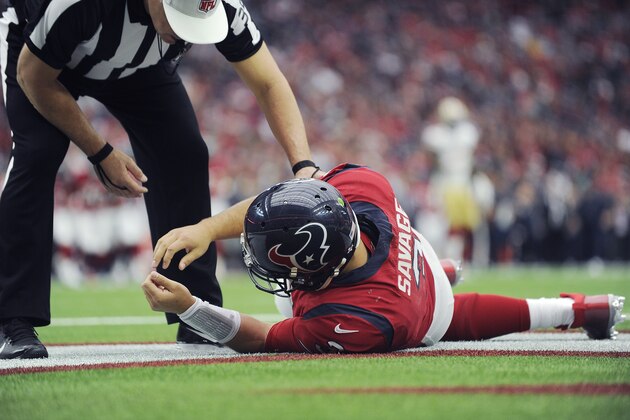 Houston Texans quarterback Tom Savage (3) is checked by a referee after he was hit during the first half of an NFL football game against the San Francisco 49ers, Sunday, Dec. 10, 2017, in Houston. Savage left the game. (AP Photo/Eric Christian Smith)
