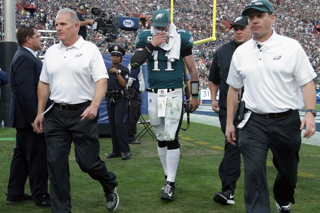 LOS ANGELES, CA - DECEMBER 10:  Carson Wentz #11 of the Philadelphia Eagles is escorted off the field at the end of the third quarter during the game against the Los Angeles Rams at the Los Angeles Memorial Coliseum on December 10, 2017 in Los Angeles, California.  (Photo by Jeff Gross/Getty Images)