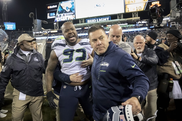 Members of the Seattle Seahawks staff escort Seattle Seahawks defensive tackle Quinton Jefferson (99) from the field after he got into a shouting match with fans, when objects were thrown at him, in the closing moments of an NFL football game against the Jacksonville Jaguars, Sunday, Dec. 10, 2017, in Jacksonville, Fla. Jacksonville won 30-24.(AP Photo/Stephen B. Morton)