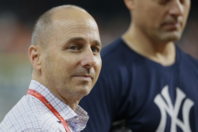 New York Yankees general manager Brian Cashman watches batting practice before Game 2 of baseball's American League Championship Series against the Houston Astros Saturday, Oct. 14, 2017, in Houston. (AP Photo/Tony Gutierrez)