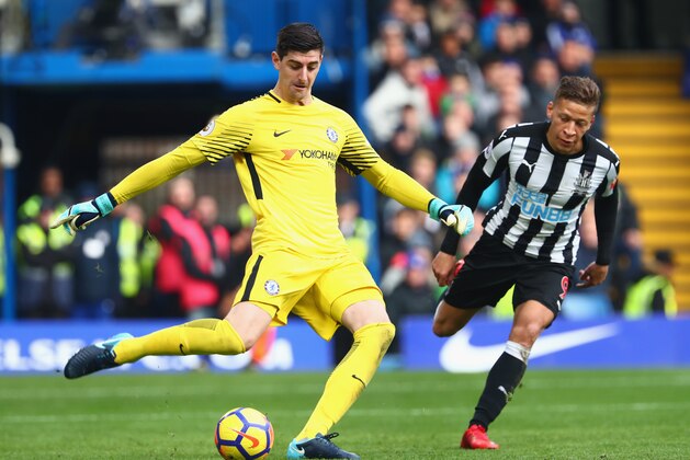 LONDON, ENGLAND - DECEMBER 02: Thibaut Courtois of Chelsea clears the ball while under pressure from Dwight Gayle of Newcastle United during the Premier League match between Chelsea and Newcastle United at Stamford Bridge on December 2, 2017 in London, England.  (Photo by Clive Rose/Getty Images)