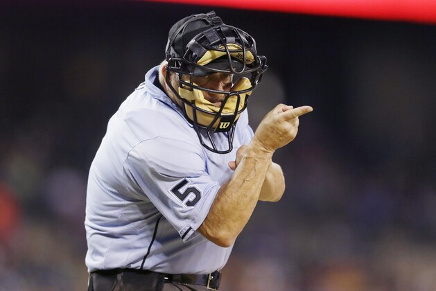 Homeplate umpire Dale Scott signals during the seventh inning of a baseball game between the Detroit Tigers and the Los Angeles Angels, Wednesday, Aug. 26, 2015, in Detroit. (AP Photo/Carlos Osorio)