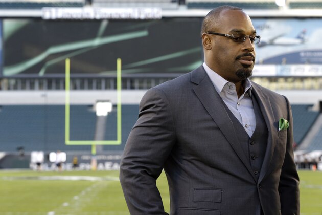FILE - In this Sept. 19, 2013, file photo, former Philadelphia Eagles quarterback Donovan McNabb pauses during a television interview before an NFL football game against the Kansas City Chiefs, in Philadelphia. McNabb will serve 18 days in an Arizona jail after he pleaded guilty to a non-extreme DUI. McNabb was stopped by police in the Phoenix suburb of Gilbert on June 28, 2015, while driving impaired. (AP Photo/Julio Cortez, File)