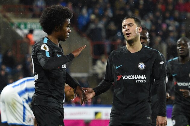 Chelsea's Brazilian midfielder Willian (L) celebrates with Chelsea's Belgian midfielder Eden Hazard (C) after scoring during the English Premier League football match between Huddersfield Town and Chelsea at the John Smith's stadium in Huddersfield, northern England on December 12, 2017. / AFP PHOTO / Oli SCARFF / RESTRICTED TO EDITORIAL USE. No use with unauthorized audio, video, data, fixture lists, club/league logos or 'live' services. Online in-match use limited to 75 images, no video emulation. No use in betting, games or single club/league/player publications.  /         (Photo credit should read OLI SCARFF/AFP/Getty Images)