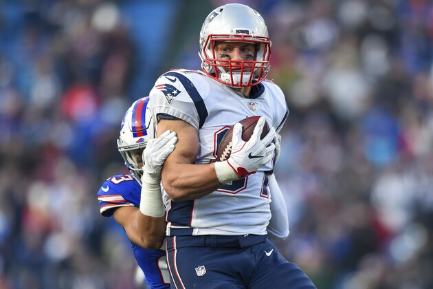 FILE - In this Dec. 3, 2017, file photo, New England Patriots tight end Rob Gronkowski (87) is tackled by Buffalo Bills strong safety Micah Hyde (23) during the second half of an NFL football game in Orchard Park, N.Y. Good news for Miami Dolphins: They won't have to face New England tight end Rob Gronkowski on Monday night. It may not matter, however, given the disparity between teams in the lopsided rivalry. Gronkowski, who caught two touchdown passes in a win over Miami two weeks ago, will sit out serving one-game suspension for late, gratuitous hit to the head of Buffalo Bills defensive back Tre'Davious White. (AP Photo/Rich Barnes, File)