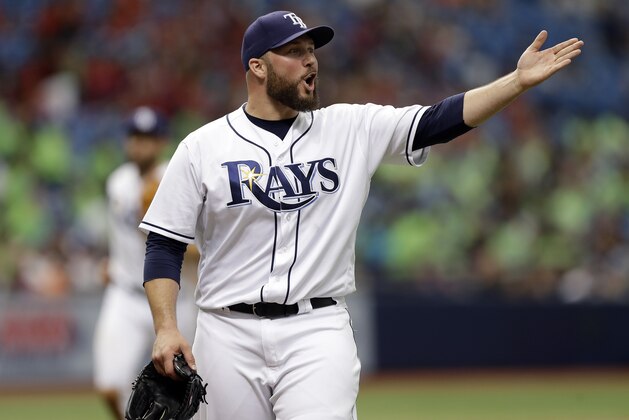 Tampa Bay Rays relief pitcher Tommy Hunter gestures to Baltimore Orioles' Adam Jones after Jones flied to right field during the eighth inning of a baseball game Wednesday, July 26, 2017, in St. Petersburg, Fla. (AP Photo/Chris O'Meara)