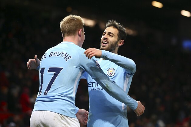 Manchester City's Bernardo Silva, right, celebrates with teammate Kevin De Bruyne at the end of the English Premier League soccer match between Manchester United and Manchester City at Old Trafford Stadium in Manchester, England, Sunday, Dec. 10, 2017. City won 2-1. (AP Photo/Dave Thompson)
