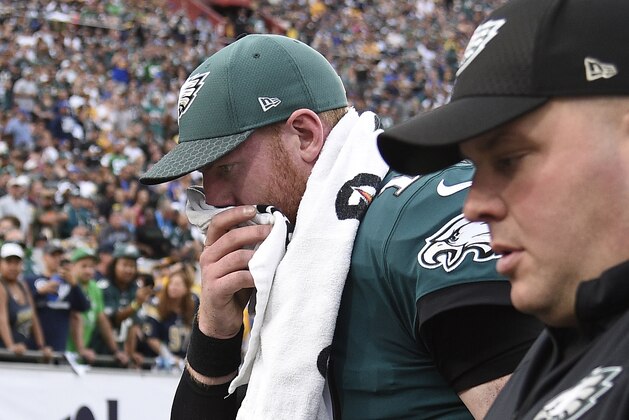 LOS ANGELES, CA - DECEMBER 10: Quarterback Carson Wentz #11 of the Philadelphia Eagles is escorted off the field after injuring his knee at the end of the third quarter during the game against the Los Angeles Rams at Los Angeles Memorial Coliseum on December 10, 2017 in Los Angeles, California. (Photo by Kevork Djansezian/Getty Images)
